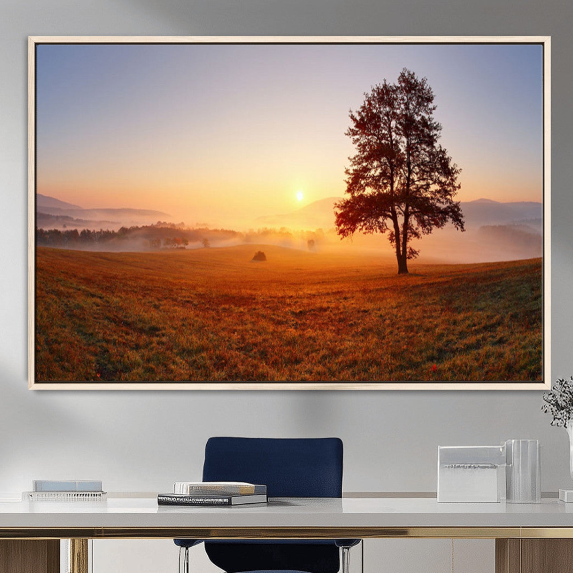 A tranquil landscape at sunrise with a mist-covered field and a lone tree, creating a peaceful and natural atmosphere.