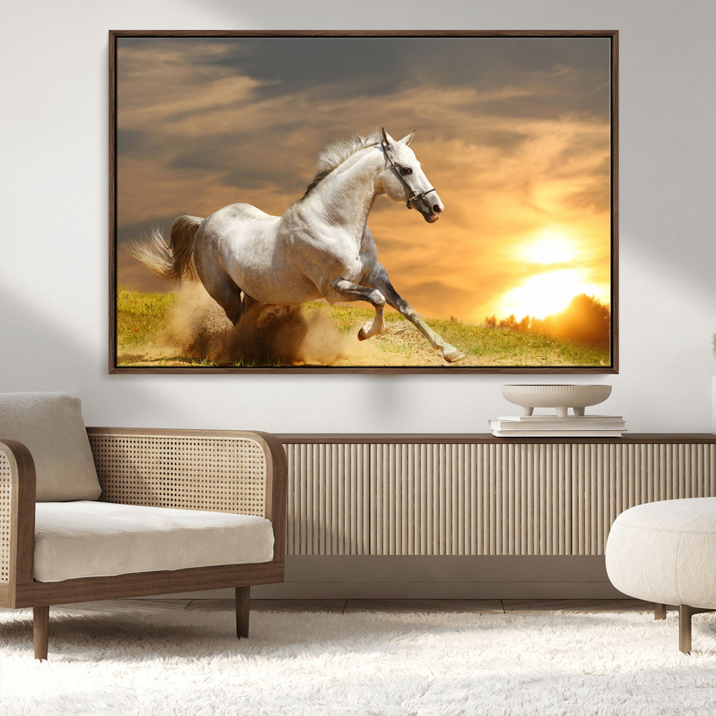 A powerful white horse galloping through the field at sunset, with the golden light illuminating its mane and the vibrant sky in the background.