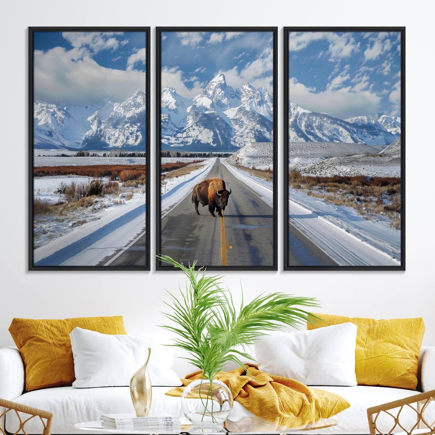 A powerful bison stands on a snow-dusted road beneath the towering peaks of the Grand Tetons, capturing the untamed beauty of America's winter wilderness.