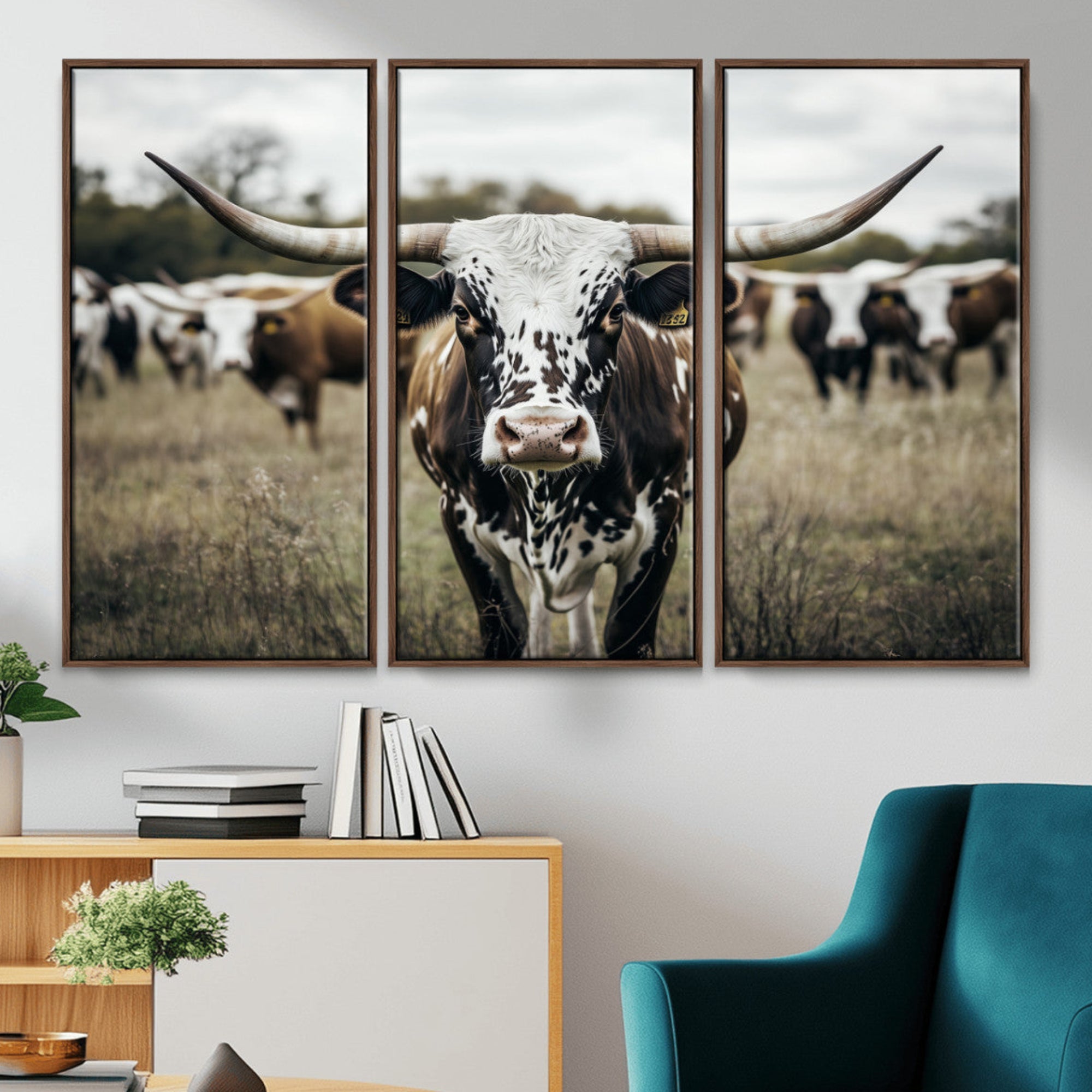 Canvas of a speckled Texas longhorn standing boldly in a field with a herd behind, perfect for rustic western or farmhouse wall decor.
