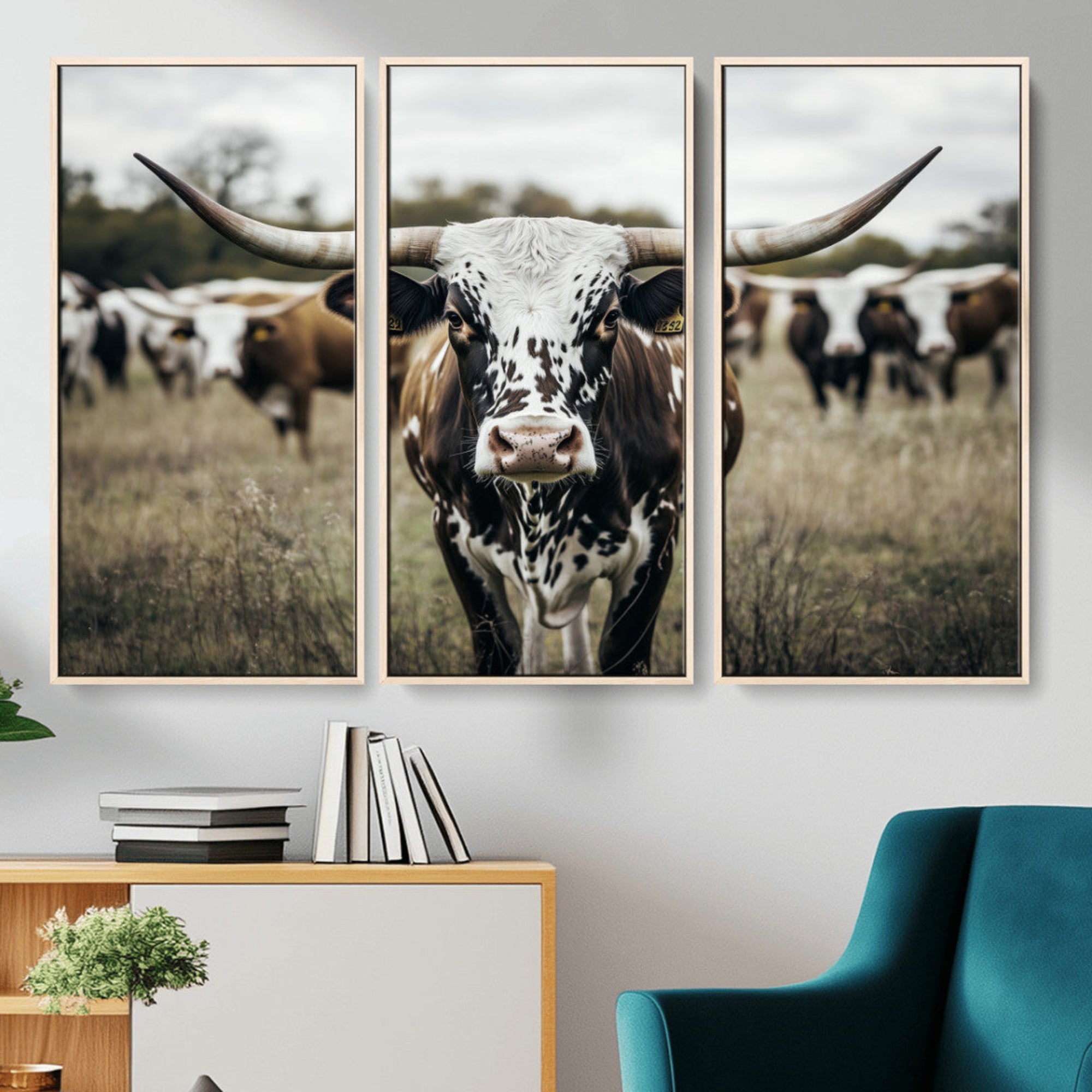 Canvas of a speckled Texas longhorn standing boldly in a field with a herd behind, perfect for rustic western or farmhouse wall decor.