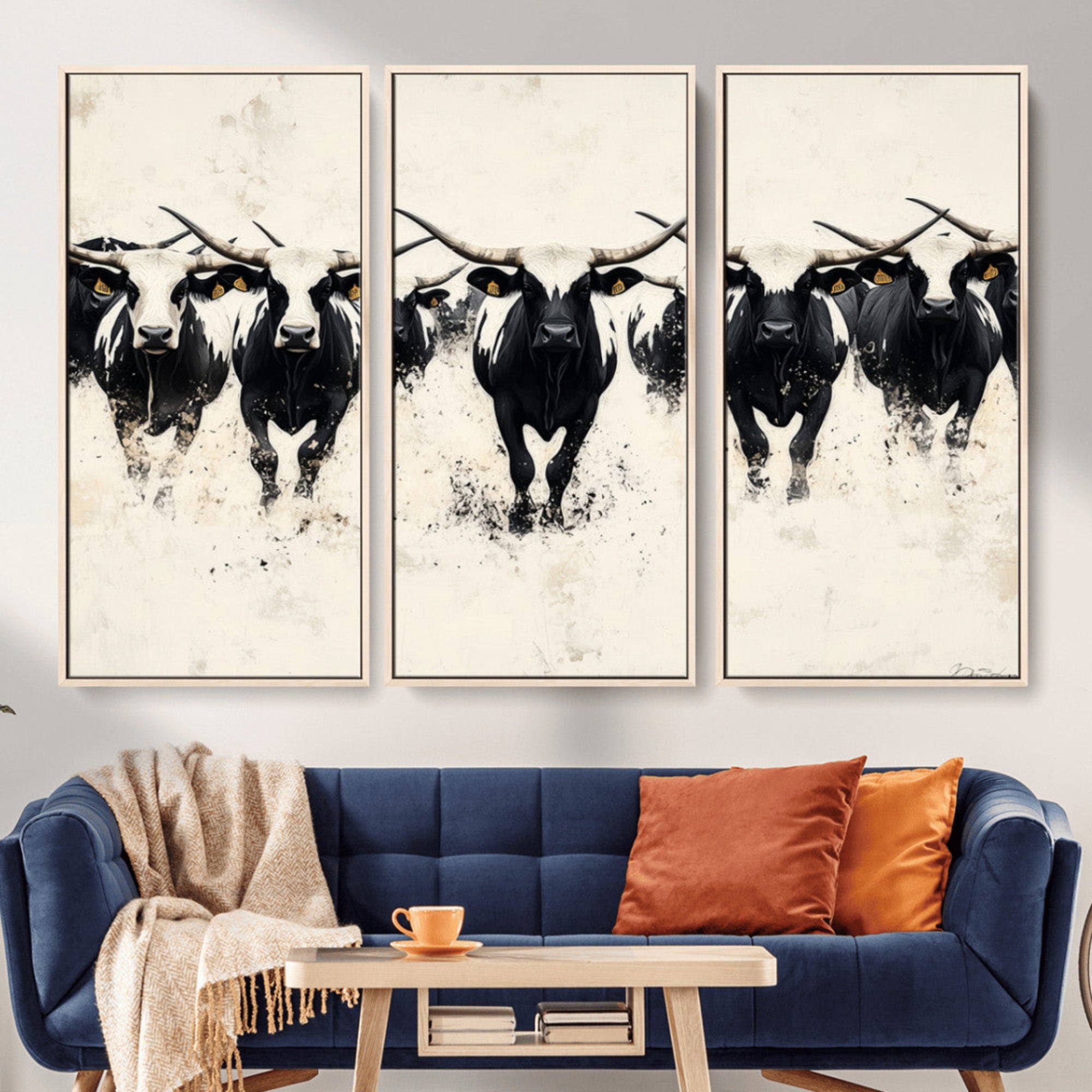 Canvas artwork of black and white Texas longhorns in a bold stampede over a minimalist background, ideal for rustic modern or Western-themed decor.