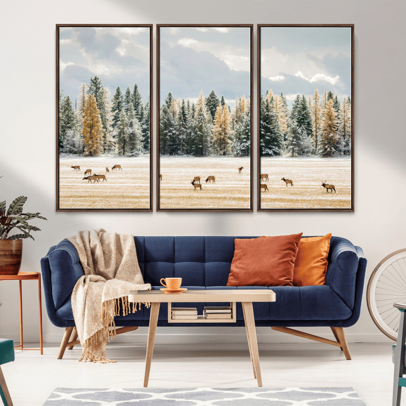 Elk herd in a snowy field with golden pine trees and frosted evergreens, ideal for neutral rustic or cabin-style home decor.