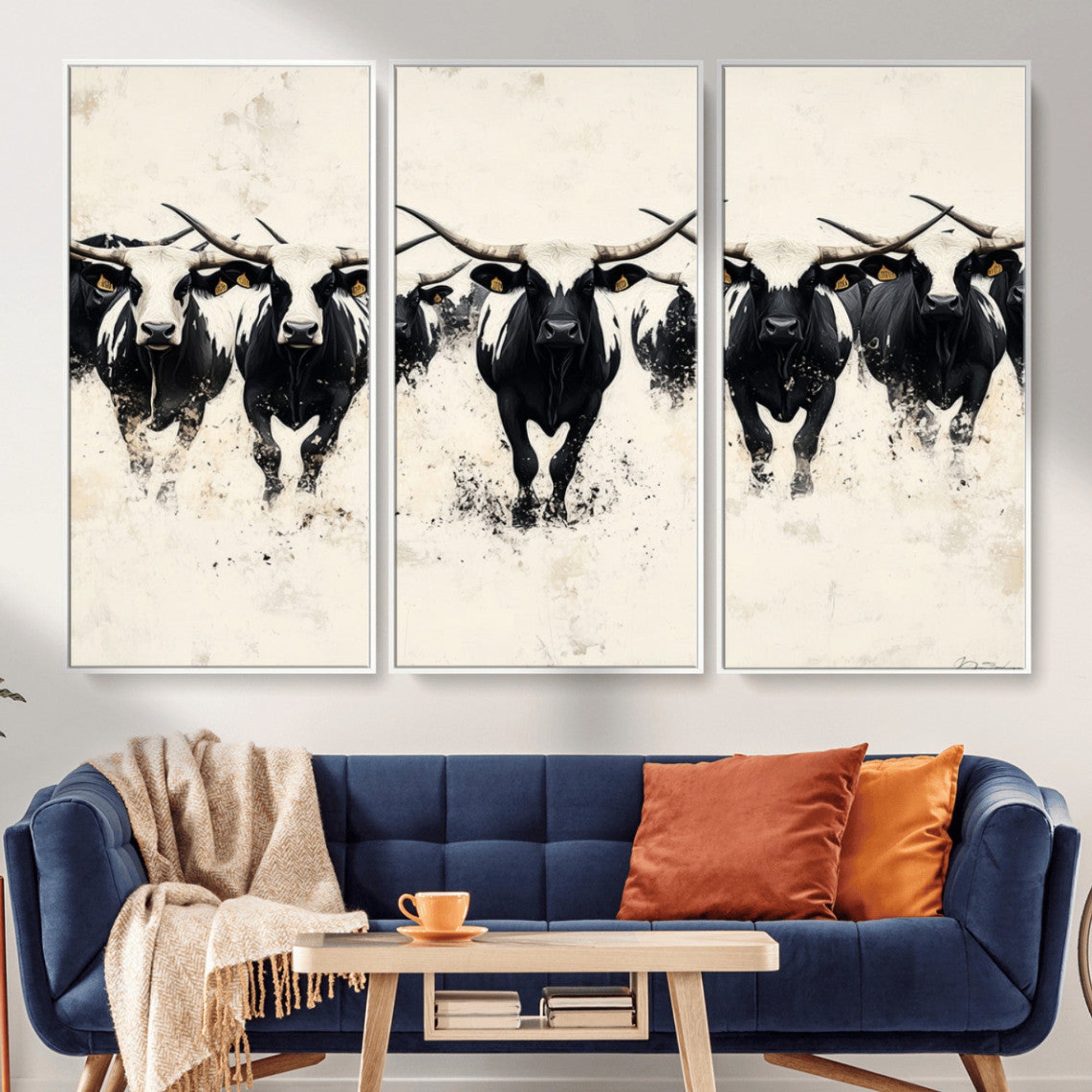 Canvas artwork of black and white Texas longhorns in a bold stampede over a minimalist background, ideal for rustic modern or Western-themed decor.