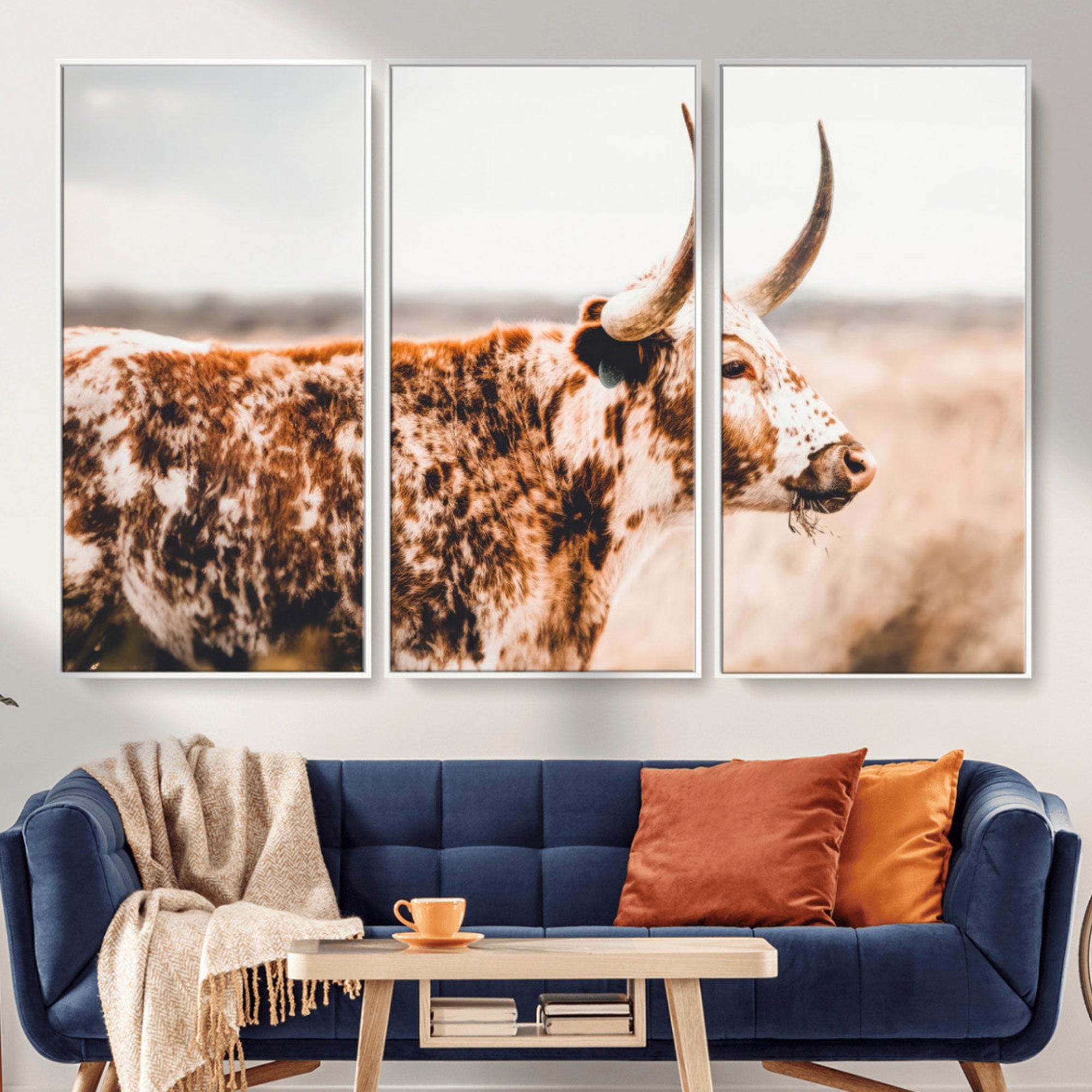 Speckled Texas longhorn with curved horns standing in a warm-toned prairie, perfect for rustic or country-style home decor.
