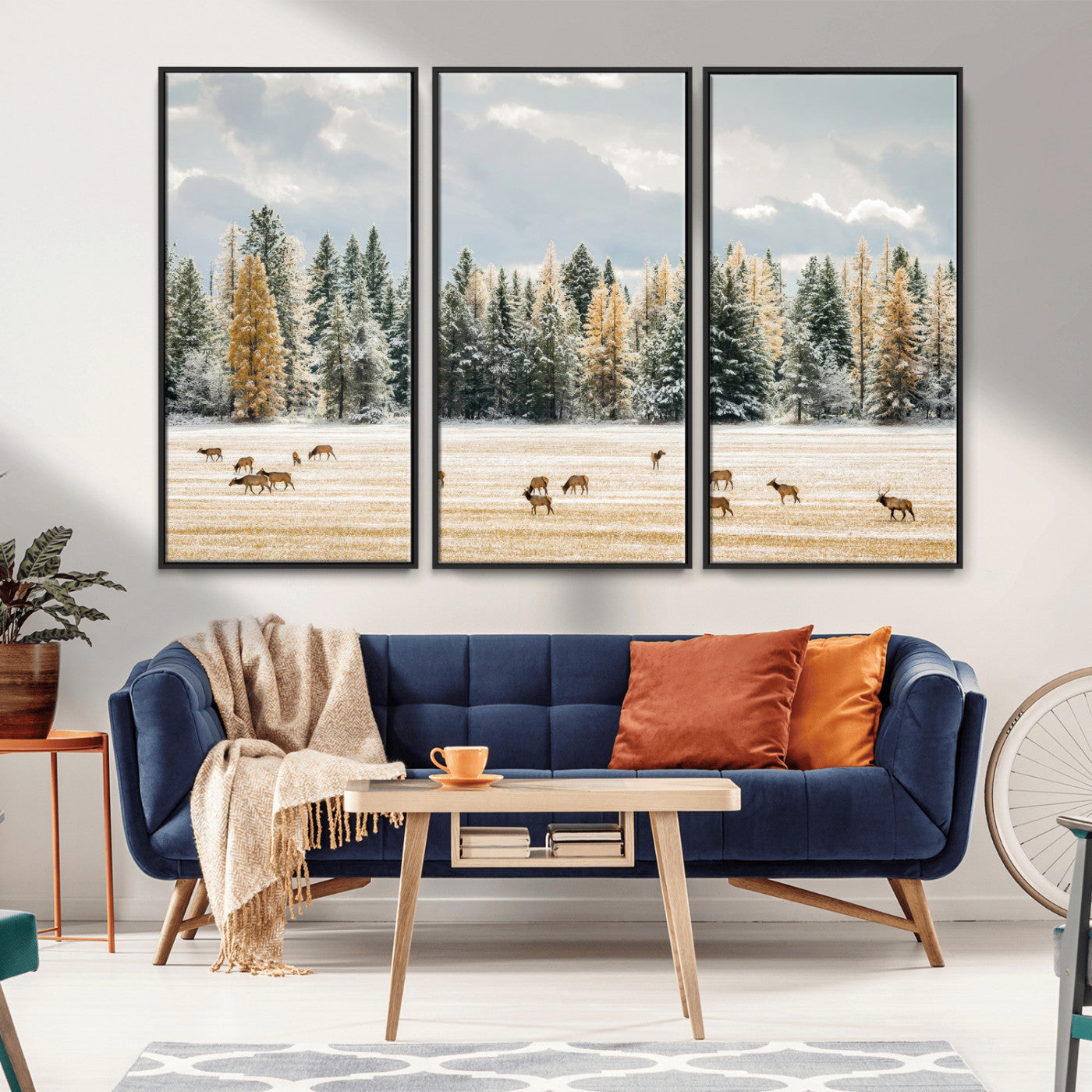Elk herd in a snowy field with golden pine trees and frosted evergreens, ideal for neutral rustic or cabin-style home decor.