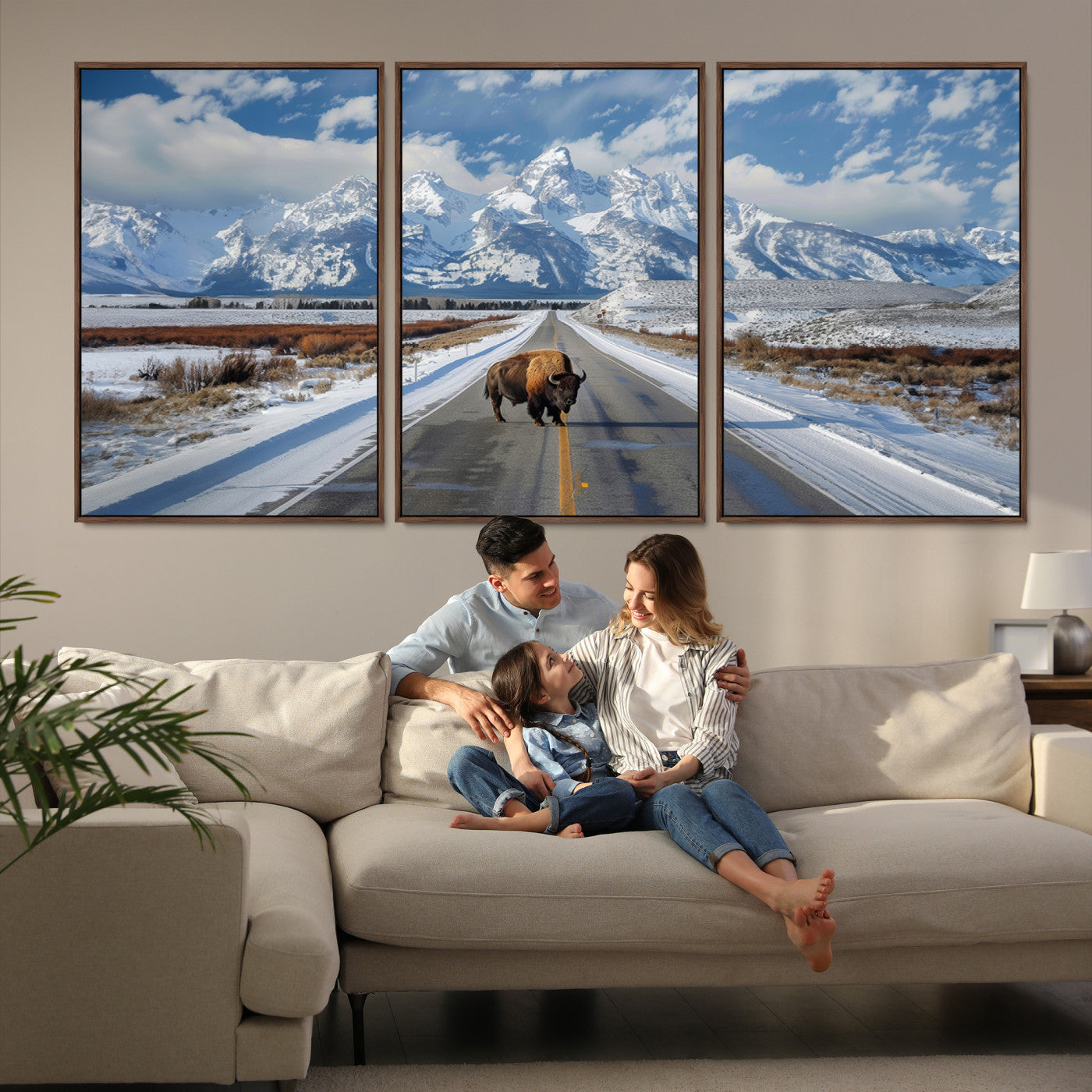 A powerful bison stands on a snow-dusted road beneath the towering peaks of the Grand Tetons, capturing the untamed beauty of America's winter wilderness.