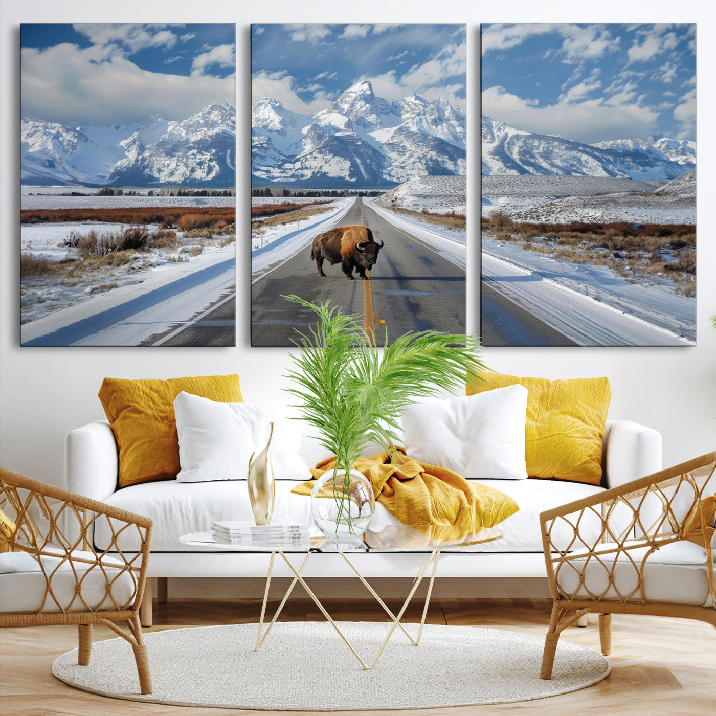 A powerful bison stands on a snow-dusted road beneath the towering peaks of the Grand Tetons, capturing the untamed beauty of America's winter wilderness.