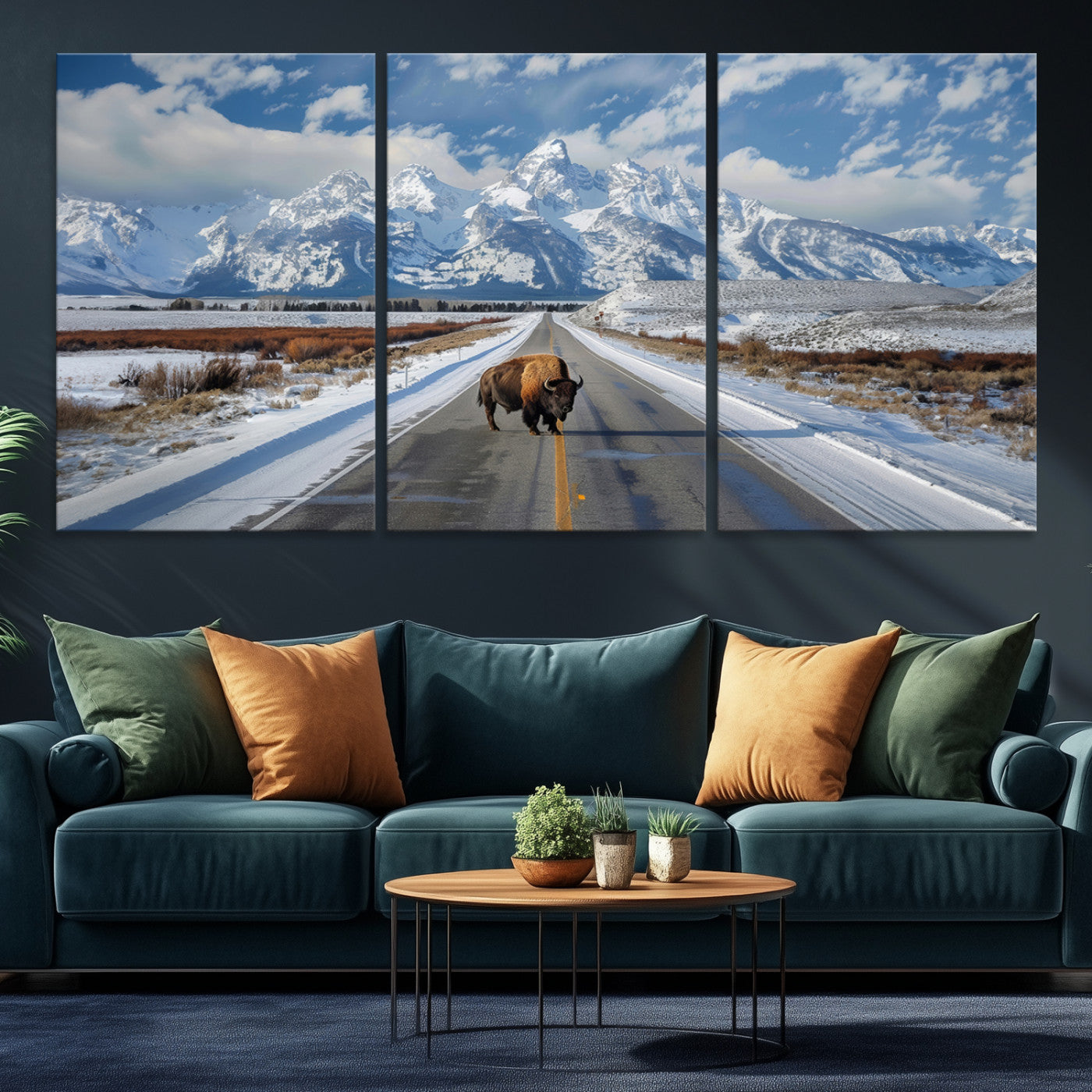 A powerful bison stands on a snow-dusted road beneath the towering peaks of the Grand Tetons, capturing the untamed beauty of America's winter wilderness.