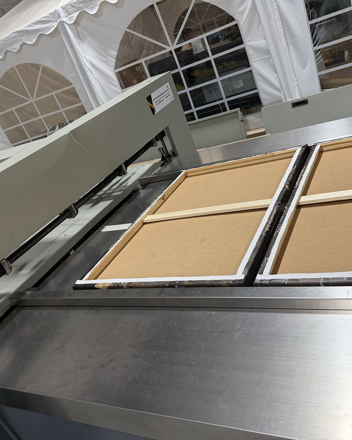 Stretching canvas on our machine.