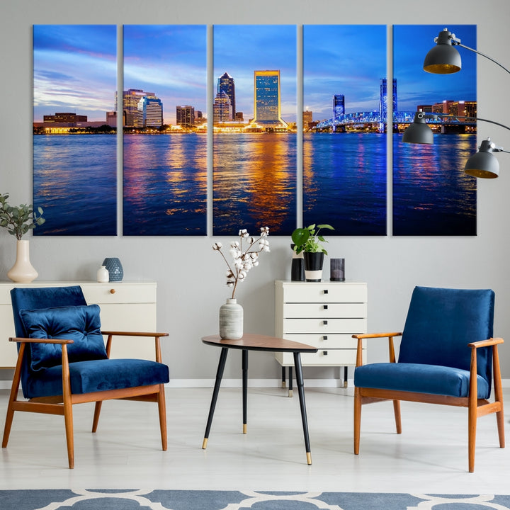 A cozy living room features the Jacksonville Wall Art Canvas Print, a large triptych crafted on museum-quality canvas that beautifully depicts the Jacksonville city skyline at sunset.