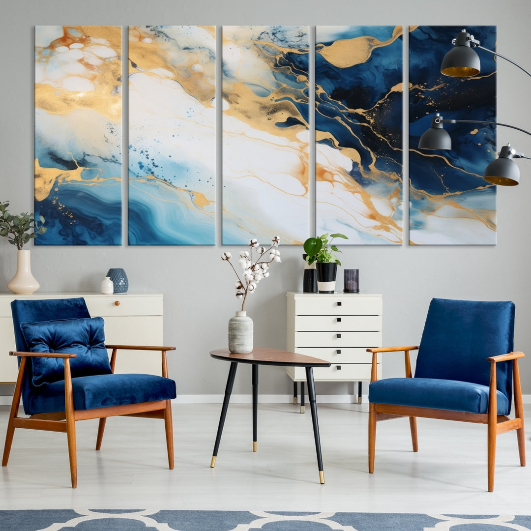 A modern living room featuring museum-quality Blue Gold Abstract Wall Art Print Contemporary art in a triptych arrangement.