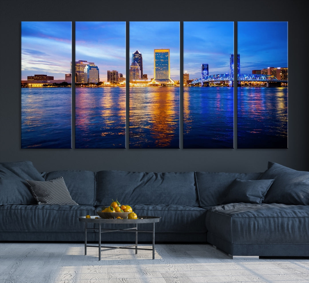 A cozy living room features the Jacksonville Wall Art Canvas Print, a large triptych crafted on museum-quality canvas that beautifully depicts the Jacksonville city skyline at sunset.