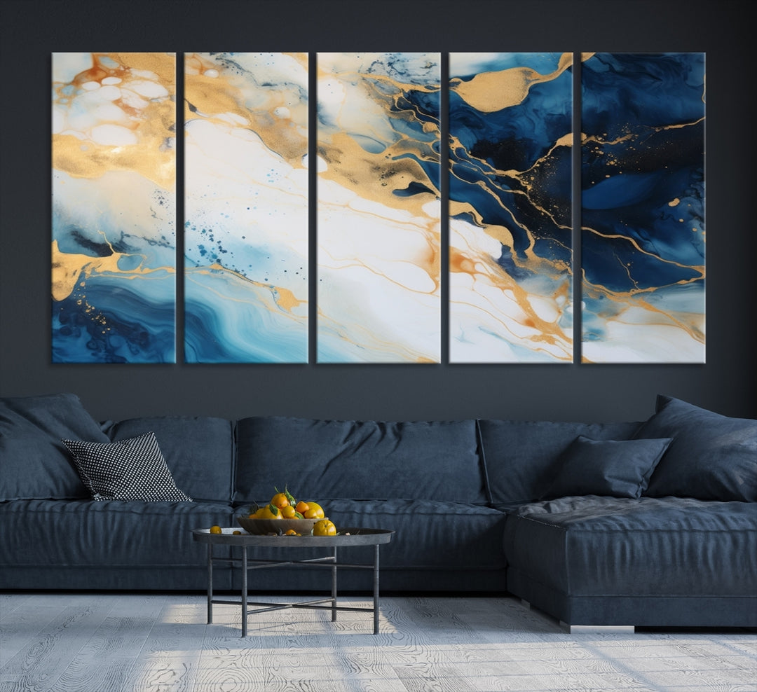 A modern living room featuring museum-quality Blue Gold Abstract Wall Art Print Contemporary art in a triptych arrangement.