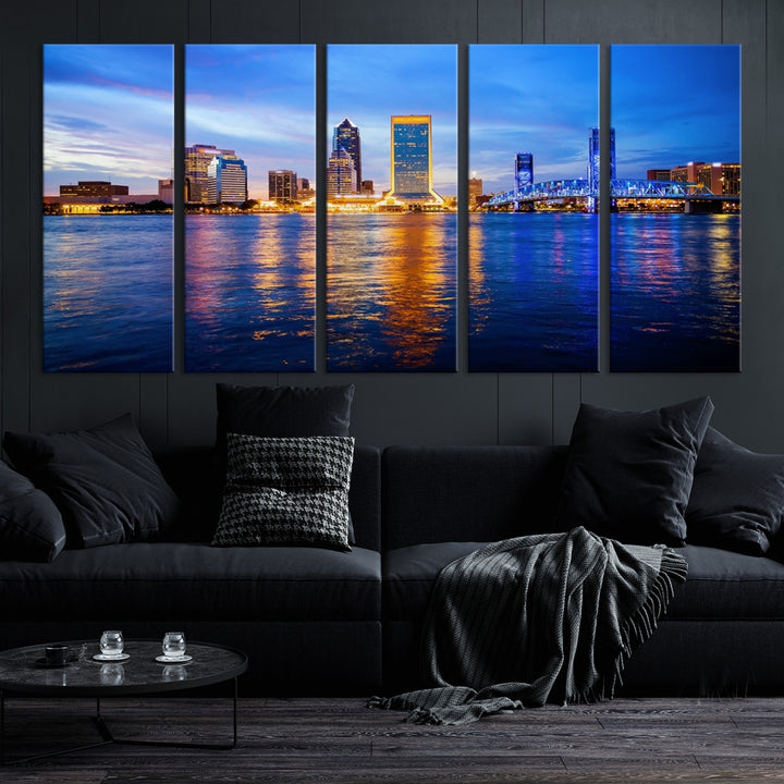 A cozy living room features the Jacksonville Wall Art Canvas Print, a large triptych crafted on museum-quality canvas that beautifully depicts the Jacksonville city skyline at sunset.