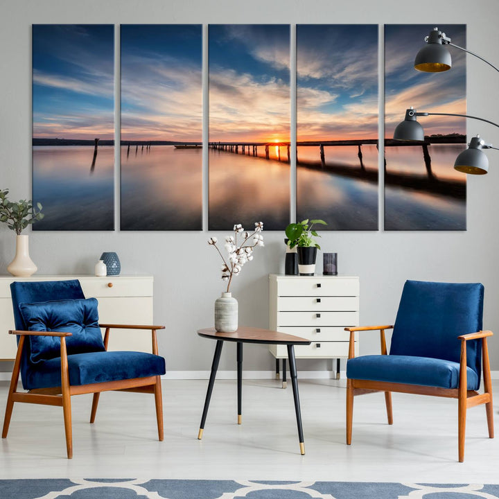 The Sunset Pier Canvas features a serene coastal landscape with vibrant hues under cloudy skies, ideal for modern decor.