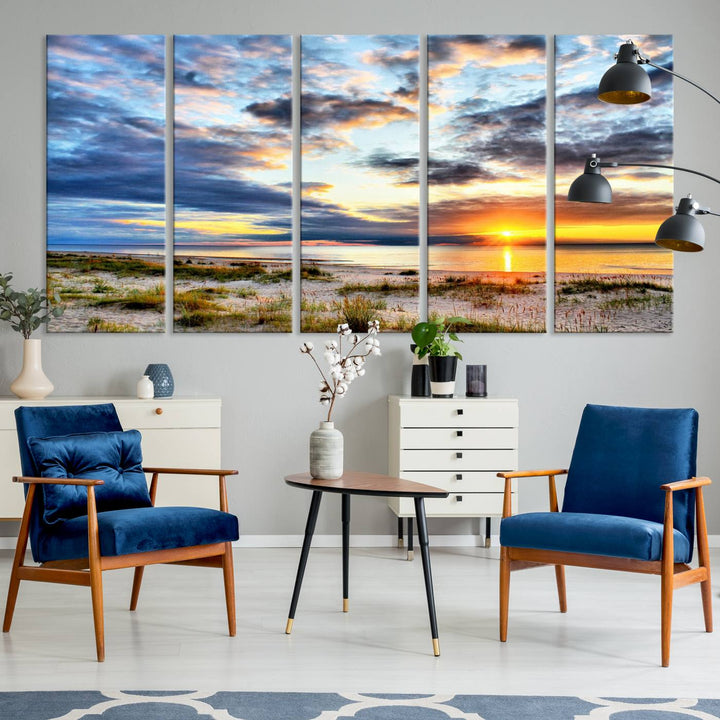 The Sunset On The Ocean canvas wall art features a beautiful beach sunset with grass and clouds.