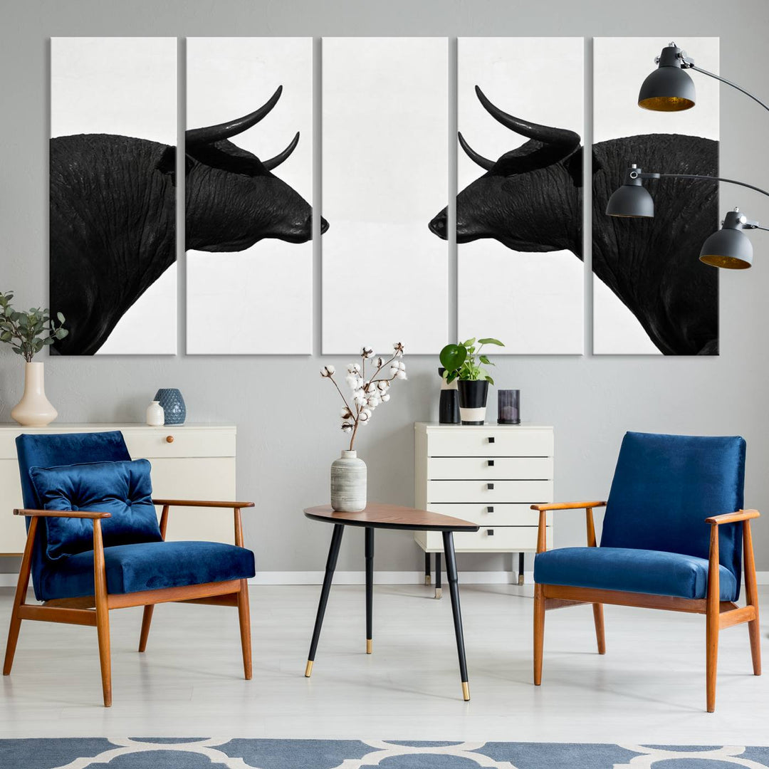 A framed canvas print featuring two black bull silhouettes, perfect for modern rustic decor.