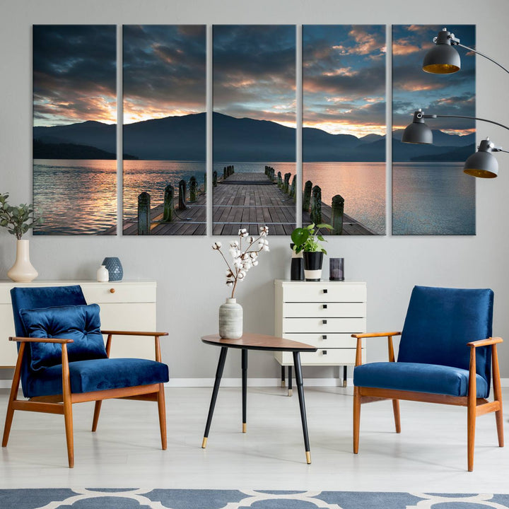 The Mountain Lake Wood Pier Canvas Wall Art depicts a serene lake and mountains, enhancing the beauty of any space.