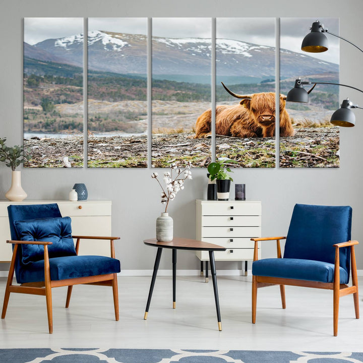 Highland Cow Horn Farm Wall Art Canvas Print is displayed against a wooden wall featuring a mountainous backdrop.