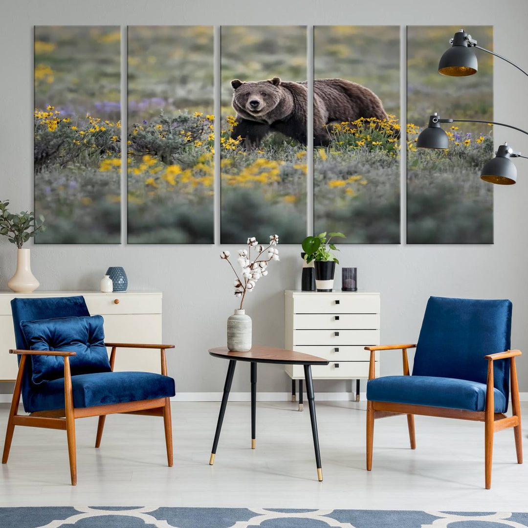 The "Grizzly 399 in Wild Flowers Wall Art Canvas Print" features a grizzly bear strolling through a field of yellow and purple flowers, beautifully showcased as a triptych. This handcrafted piece, proudly made in the USA, adds charm and sophistication to your space.