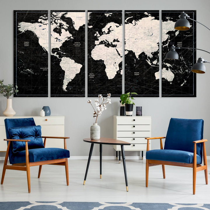 A bold global style framed black and white world map canvas print, presented in three panels, perfect for modern home or office decor.