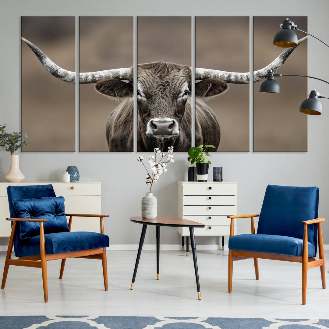 A close-up of a longhorn bull facing forward is featured in the Framed Texas Test-1, set against a blurred brown background.