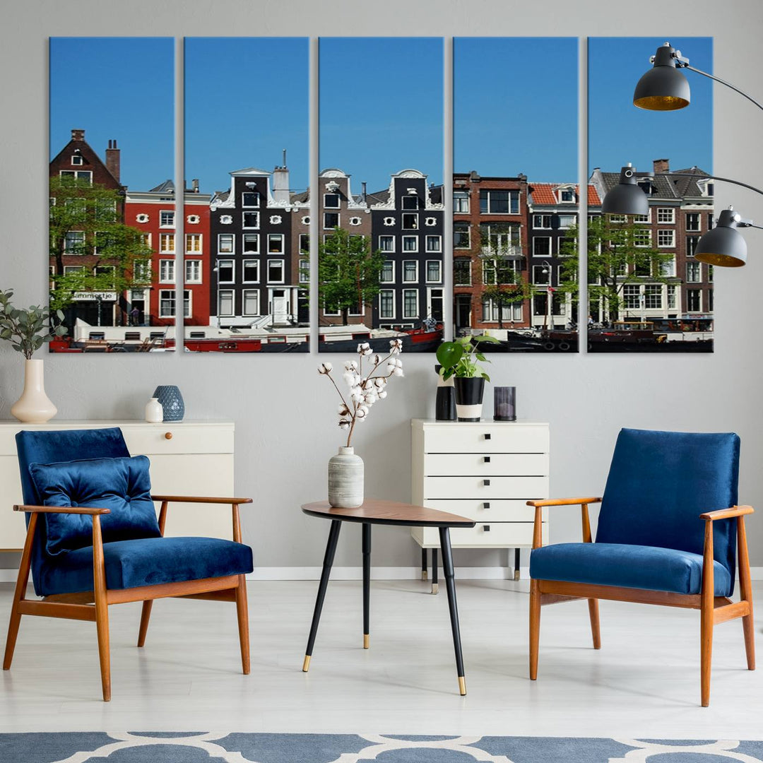 The Amsterdam City Wall Art Canvas Print showcases colorful traditional canal houses and boats set against a clear blue sky.