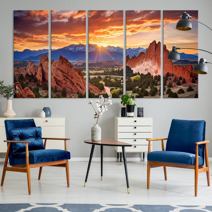 A vibrant sunset over the Rocky Mountains with red rocks.