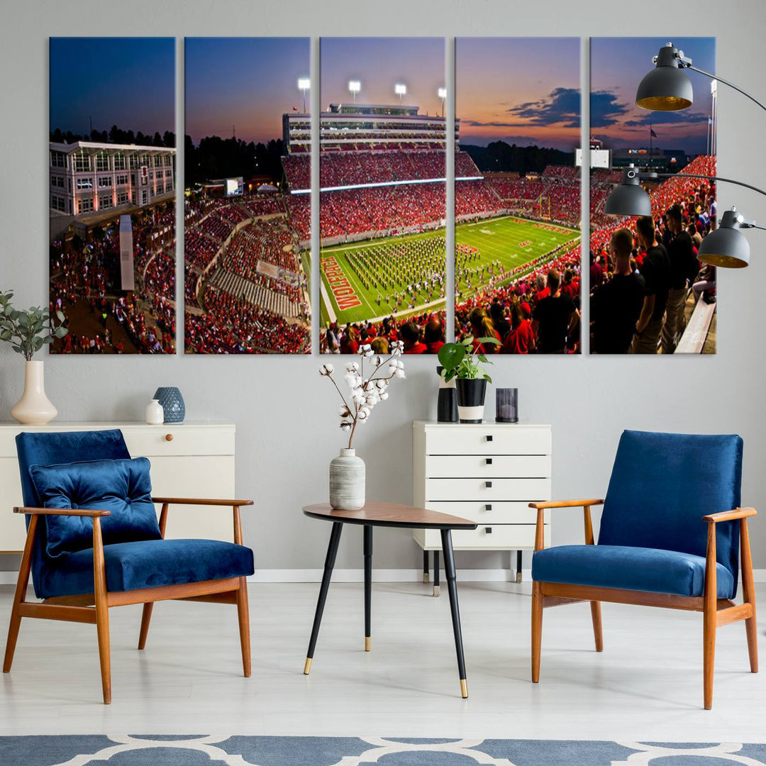 A print of a bustling Carter-Finley Stadium at dusk, featuring fans and a band, captures the essence of NC State Wolfpack football.