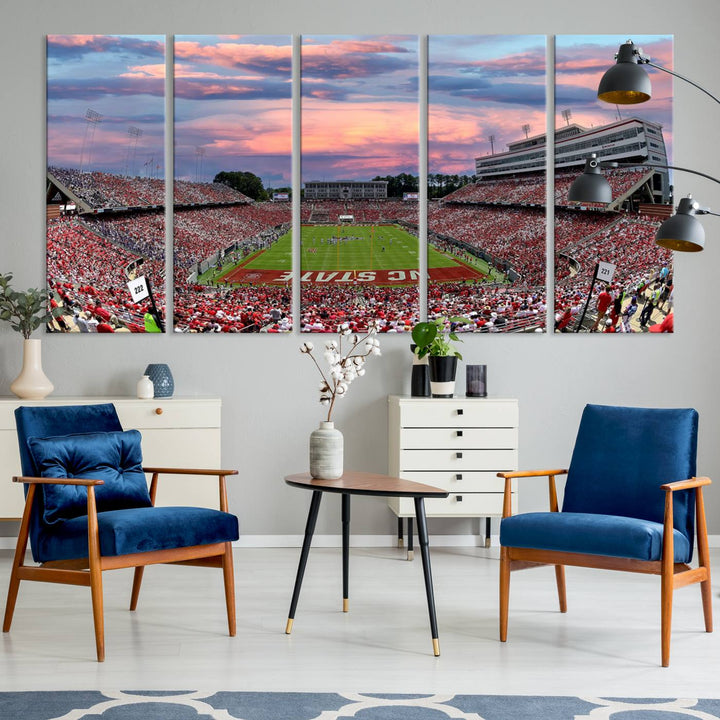 The wall art captures an NC State Wolfpack game under a vibrant sunset on triple canvas.