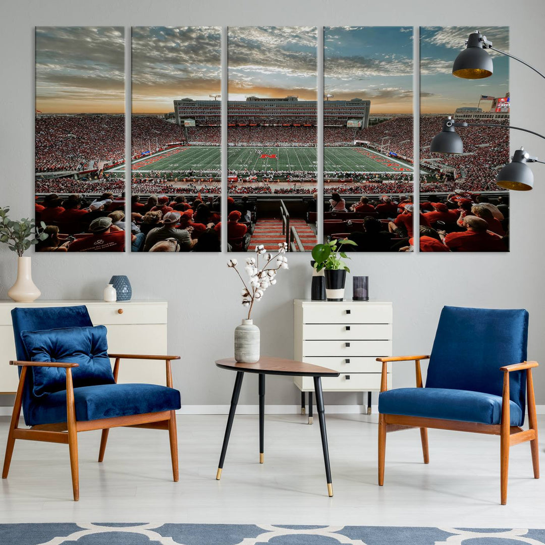 The living room features a stunning triptych of Lincoln Memorial Stadium wall art canvas print, celebrating the University of Nebraska Cornhuskers football team. This piece serves as captivating wall art, showcasing a gallery-quality finish.