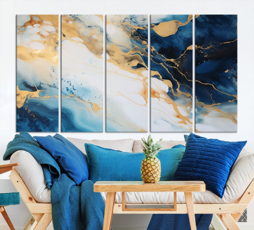 A modern living room featuring museum-quality Blue Gold Abstract Wall Art Print Contemporary art in a triptych arrangement.