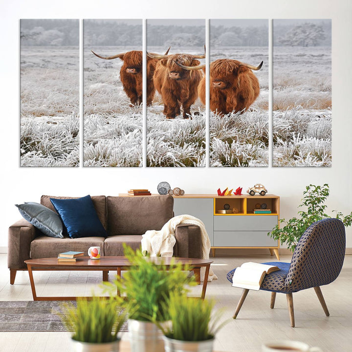 The Highland Cows in Snow canvas showcases three cattle in a frosty field.