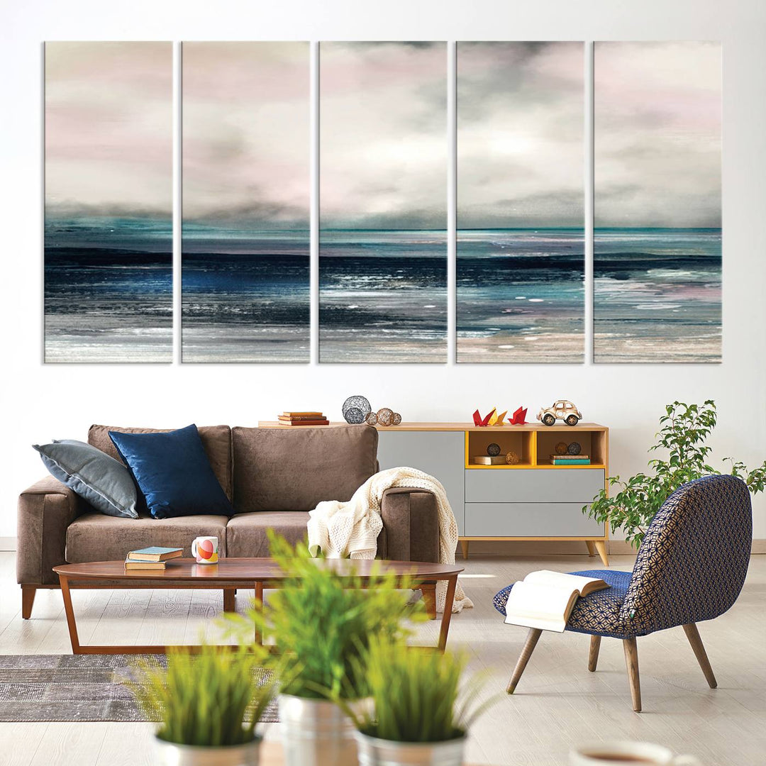 A contemporary abstract wall art canvas print in pastel pink, teal, and gray tones hangs on the wall.