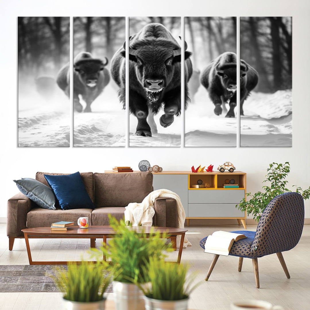 The Buffalo Wall Art Canvas Print of bison running through snow adorns the wall.