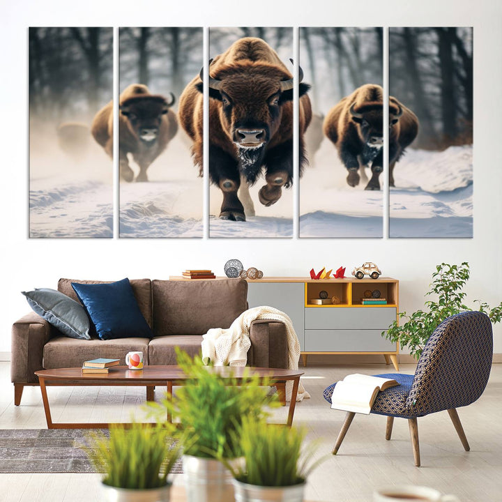 Wall art titled Cow Bighorn shows three bison running through snow in a forest.