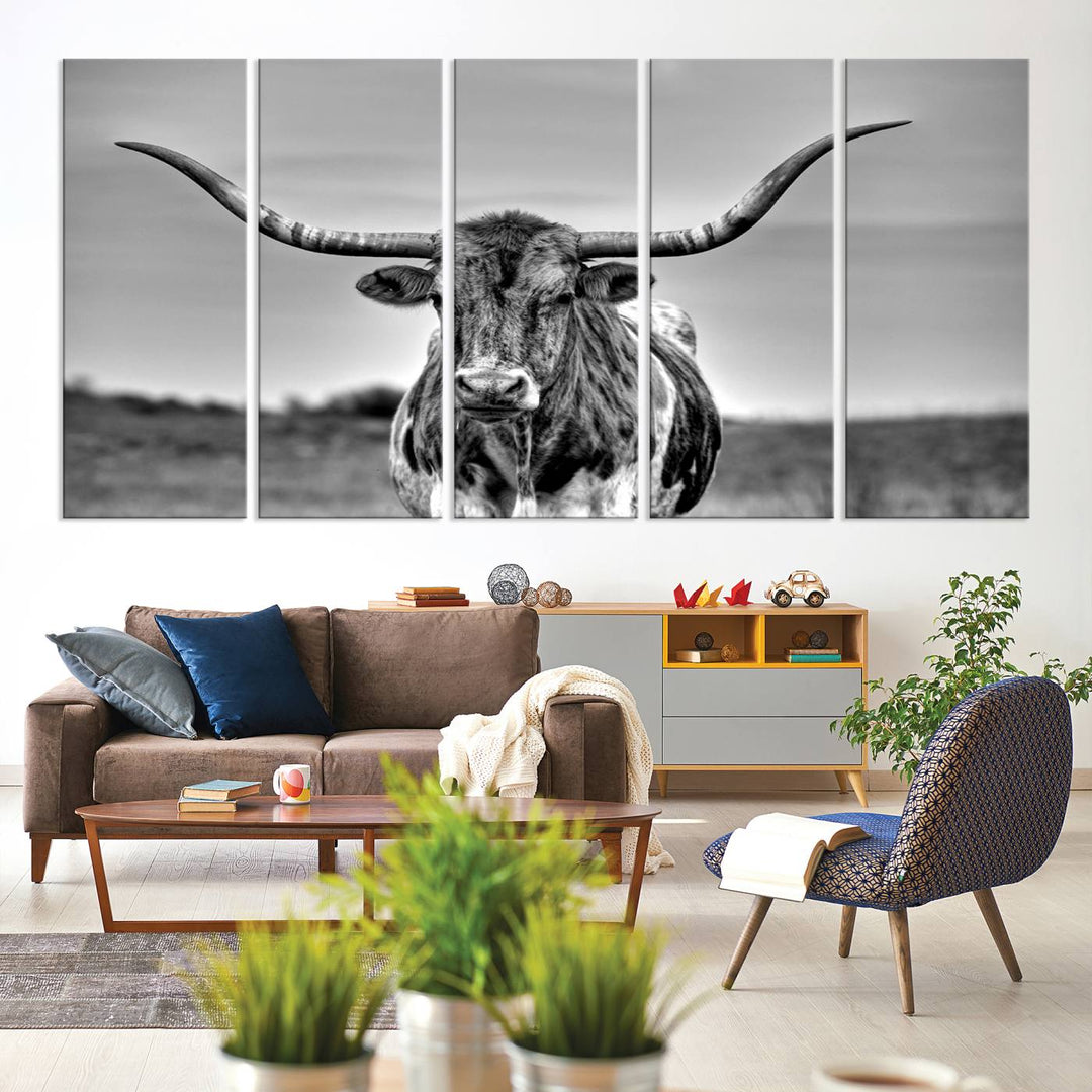 The Texas Longhorn Cow wall art, divided into three panels, is of gallery quality and displayed on a dark wall.