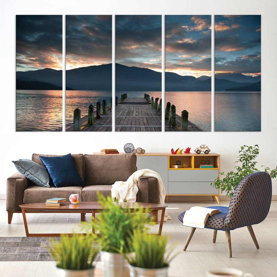 The Mountain Lake Wood Pier Canvas Wall Art depicts a serene lake and mountains, enhancing the beauty of any space.