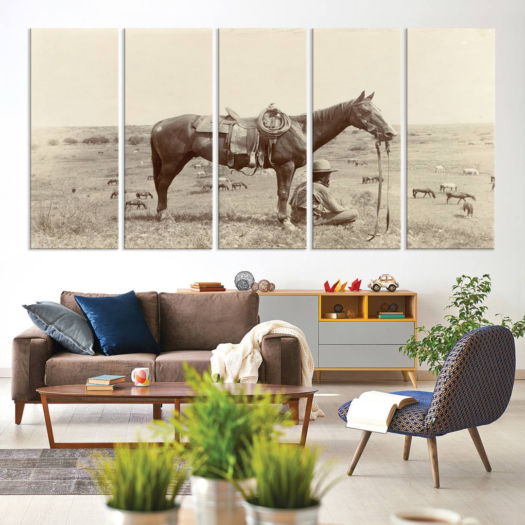 Cowboy Wall Art - Vintage Western Horse Canvas Print features a cowboy kneeling by his horse in a field.