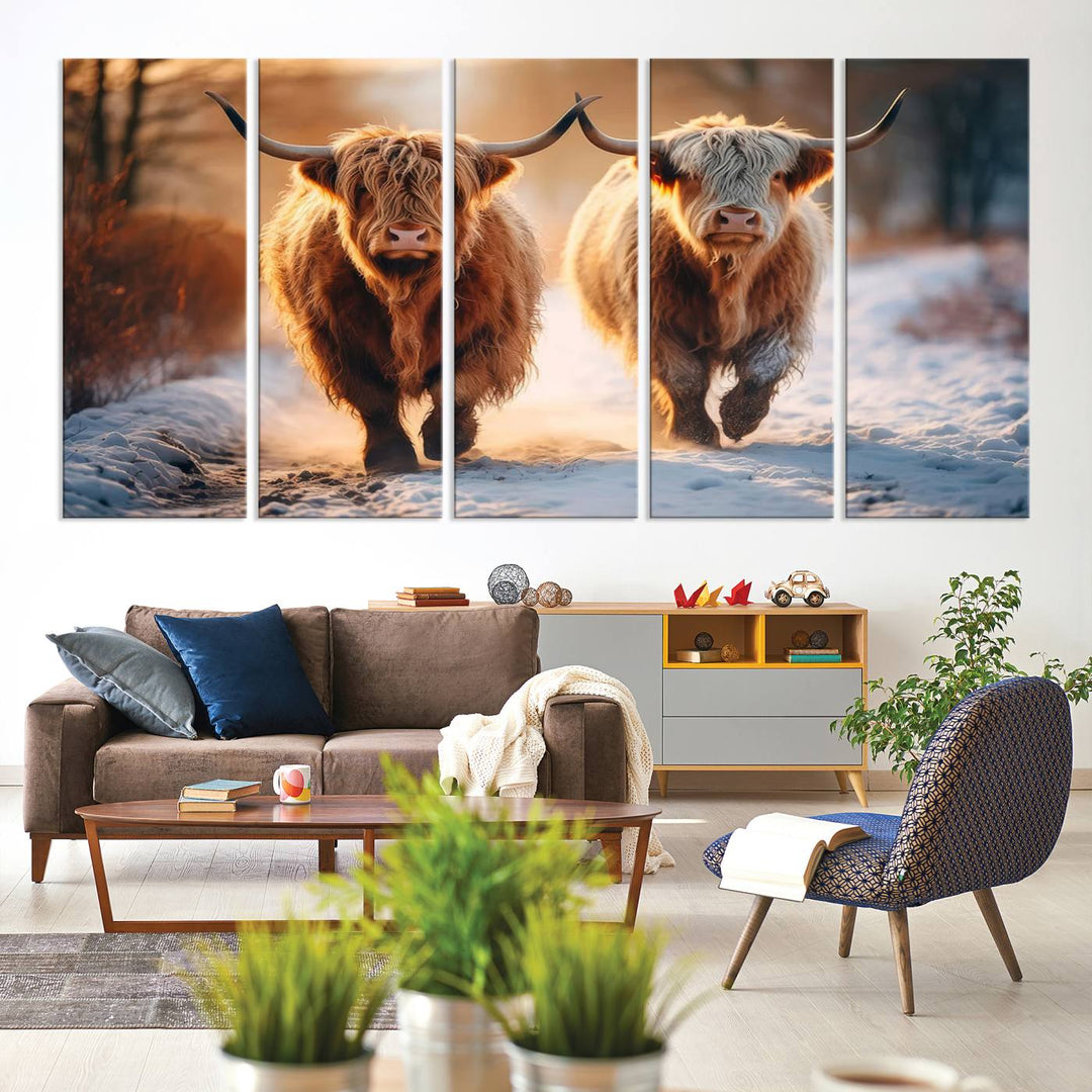 The wall art is a Scottish Highland Cow Horn canvas print featuring cows on a snowy path bathed in warm sunlight, serving as a rustic decor piece.