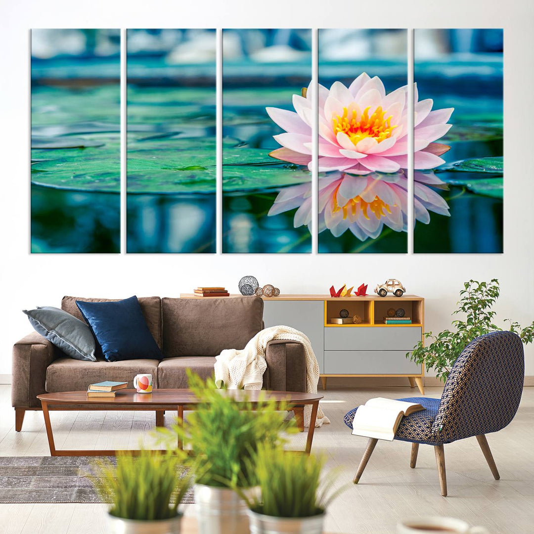 The Lotus Flower Canvas Print showcases a pink water lily with a yellow center gracefully floating on a calm pond.