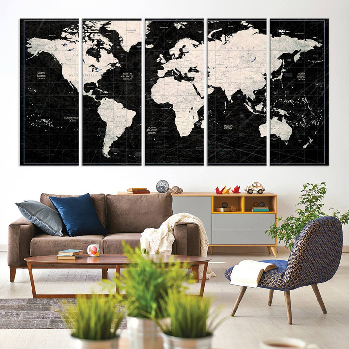 A bold global style framed black and white world map canvas print, presented in three panels, perfect for modern home or office decor.