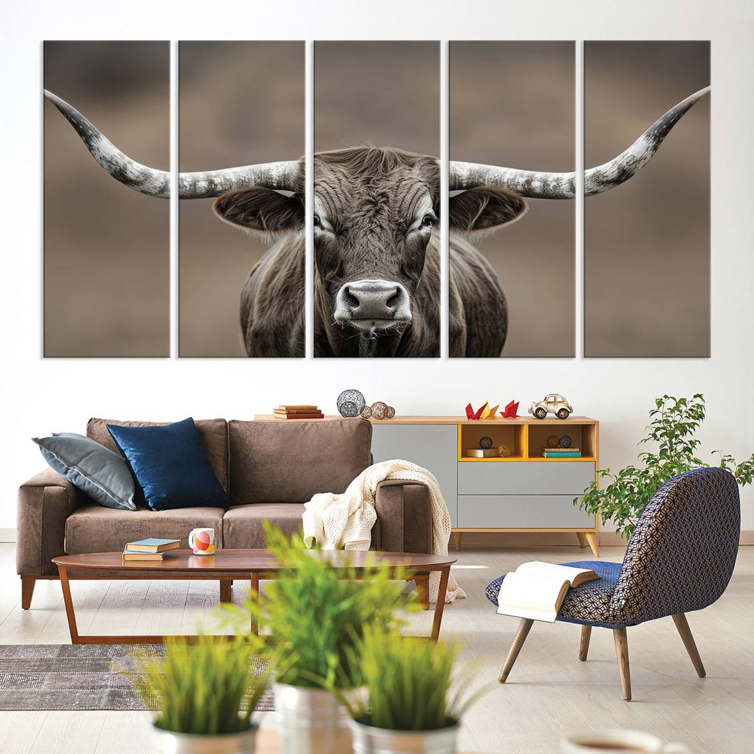 A close-up of a longhorn bull facing forward is featured in the Framed Texas Test-1, set against a blurred brown background.