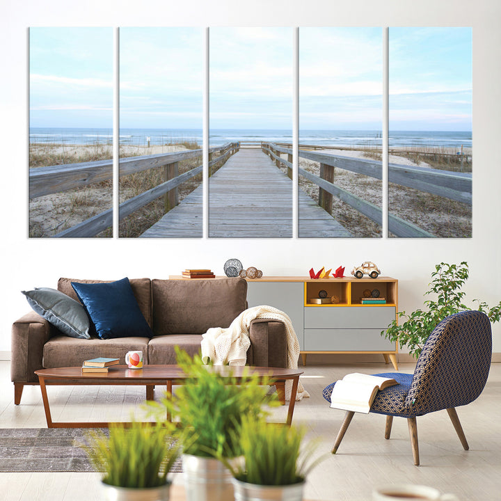 Wooden boardwalk leading to a peaceful beach with gentle ocean waves under a soft pastel sky, perfect for coastal and nautical home decor.