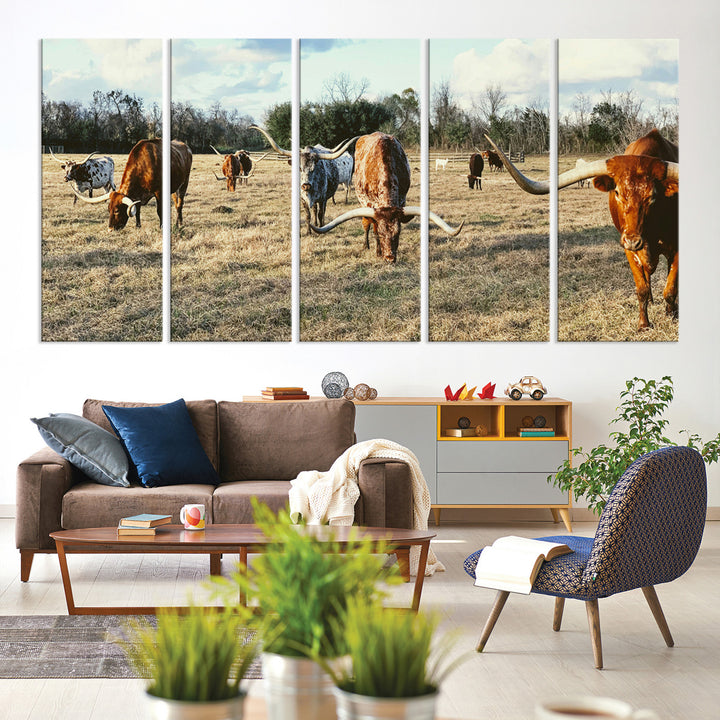 A herd of Texas Longhorn cattle grazing in an open field under a partly cloudy sky, capturing a rustic and Western ranch aesthetic.