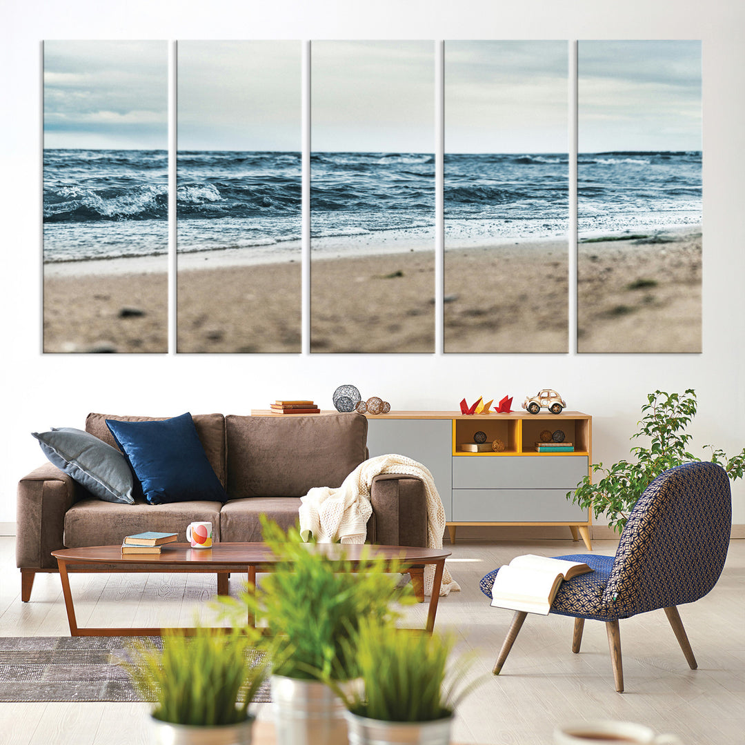 A moody ocean scene with gentle waves washing onto a sandy beach under a cloudy sky, creating a peaceful and coastal atmosphere.