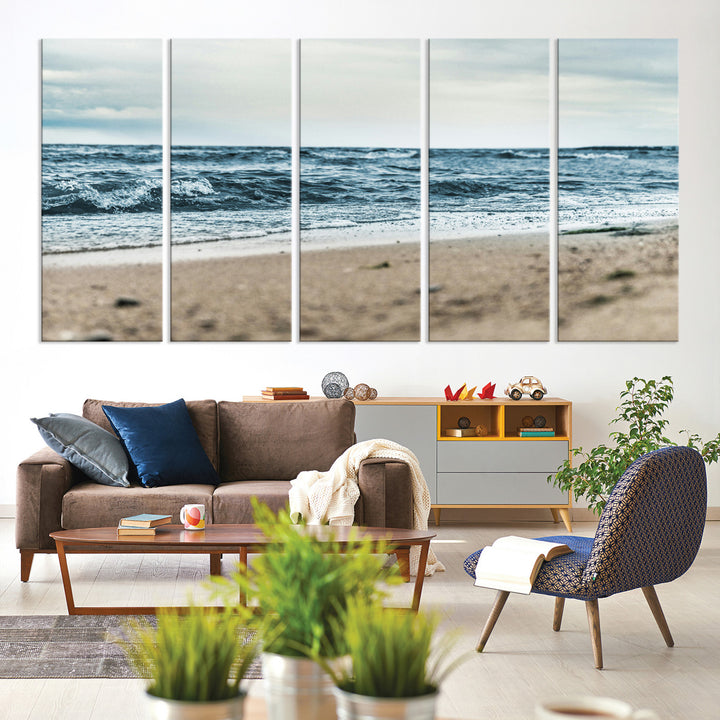 A moody ocean scene with gentle waves washing onto a sandy beach under a cloudy sky, creating a peaceful and coastal atmosphere.