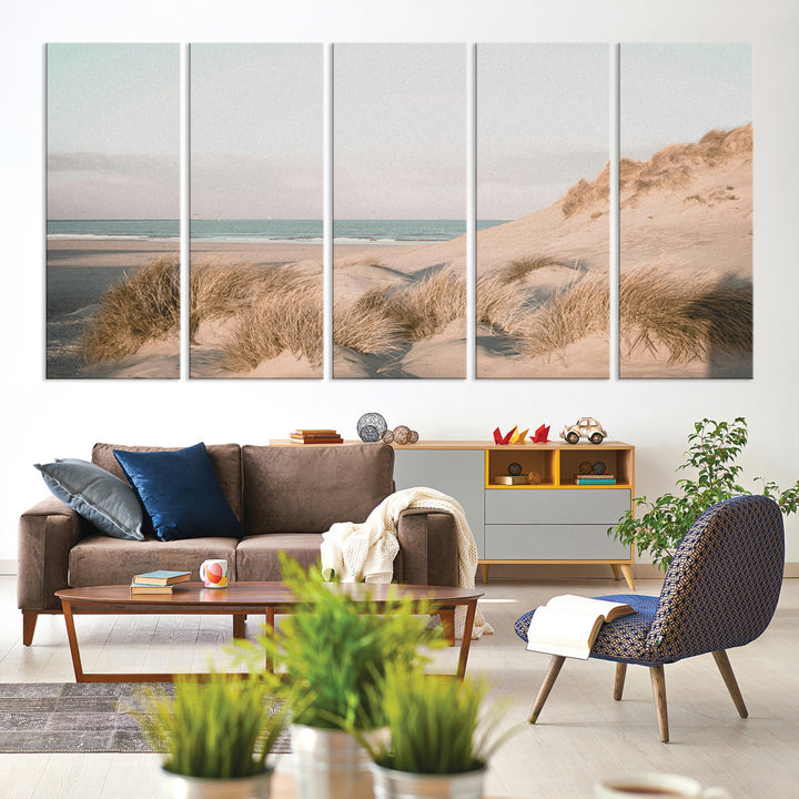Soft pastel-toned beach scene with sand dunes, windswept grasses, and a calm ocean horizon, creating a serene coastal atmosphere.