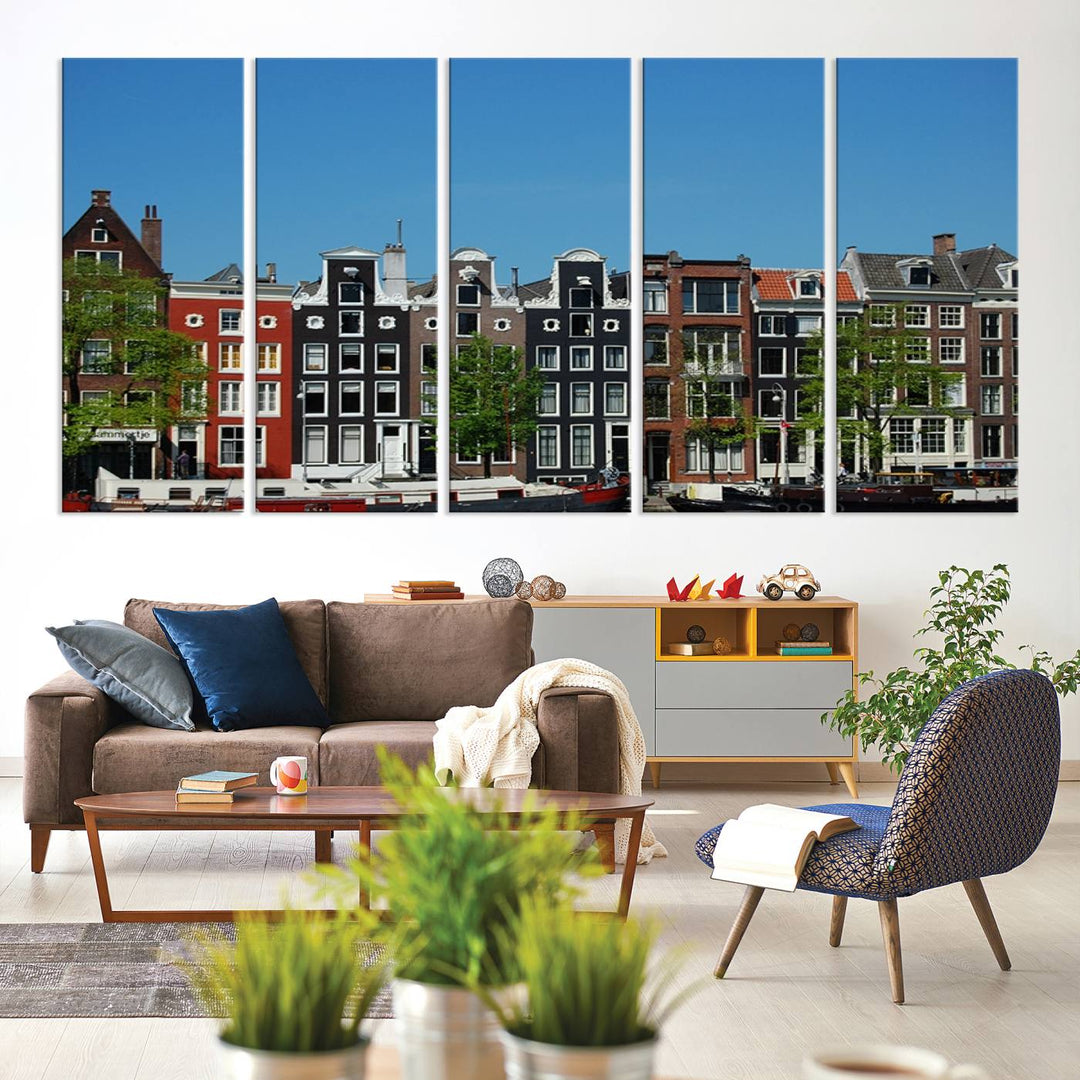 The Amsterdam City Wall Art Canvas Print showcases colorful traditional canal houses and boats set against a clear blue sky.